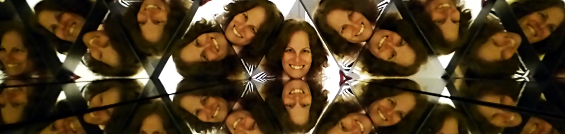 Author Adva Shaviv's face multiplied numerous times in a human-sized kaleidoscope.
